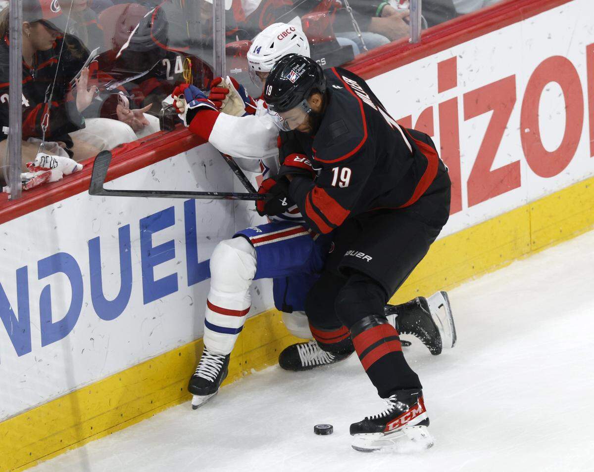 Carolina's K'andre Miller (19) checks Montréal's Nick Suzuki (14) as he controls the puck in the second period of the Hurricanes’ game against the Canadiens in game five of the Eastern Conference Finals at the Lenovo Center Friday, May 29, 2026.