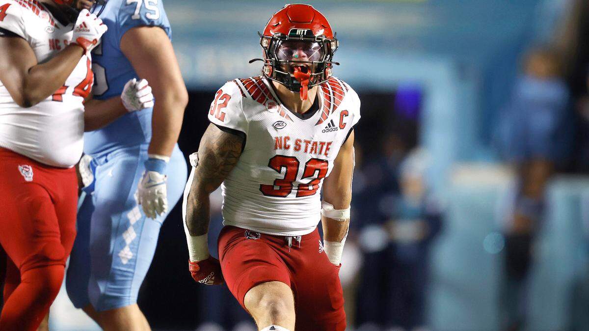 N.C. State linebacker Drake Thomas (32) celebrates after sacking North Carolina quarterback Drake Maye (10) during the Wolfpack’s 30-27 overtime victory over UNC at Kenan Stadium in Chapel Hill, N.C., Friday, Nov. 25, 2022.