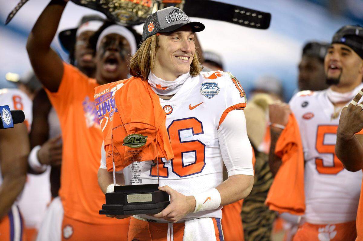 Clemson Tigers quarterback Trevor Lawrence holds the MVP trophy smiling following the ACC Championship game. Clemson defeated Notre Dame 34-10 to win the championship at Bank of America Stadium in Charlotte, NC on Saturday, December 19, 2020.  