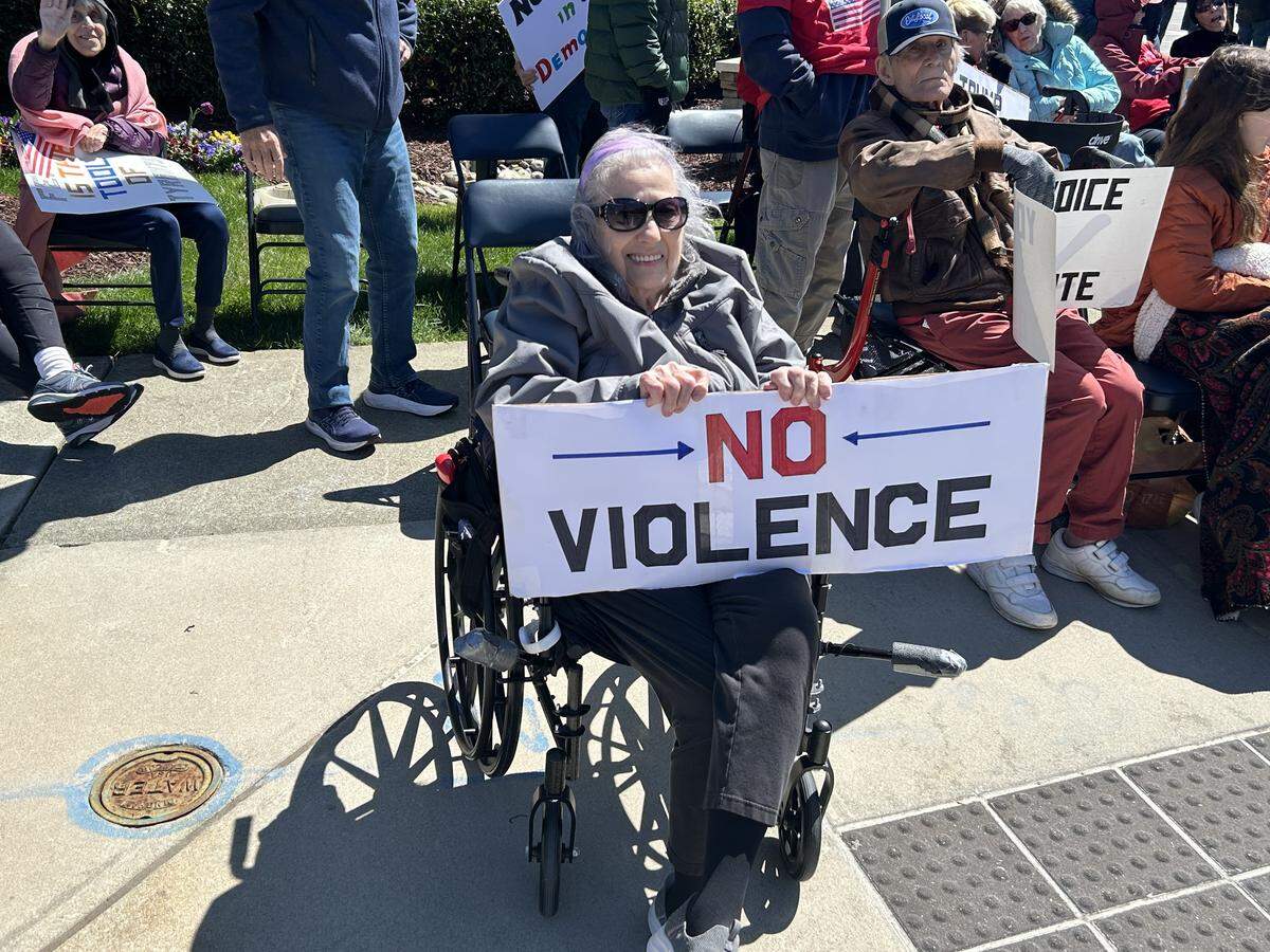 Peggy Naylor, 77, joined a senior citizens “No Kings” rally outside The Cambridge at Brier Creek in North Raleigh Saturday.