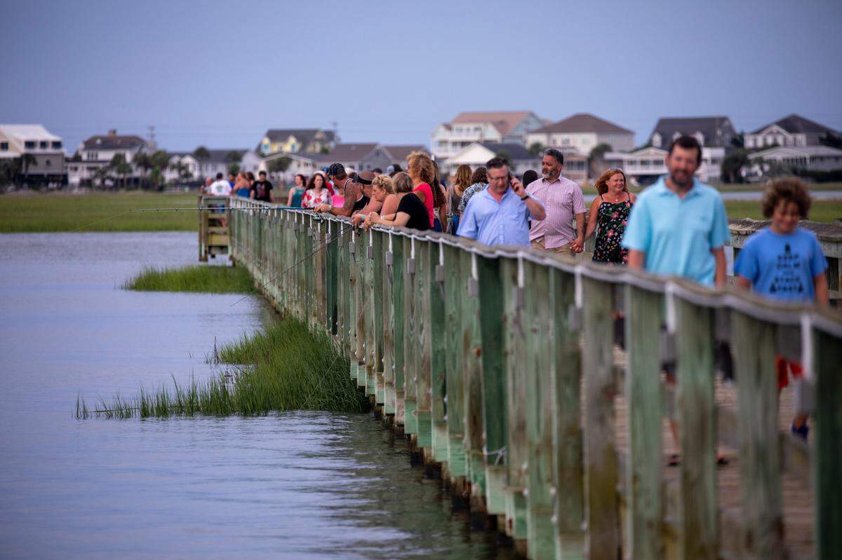 Visitors to the Veterans Pier along the Murrells Inlet Waterfront a King Tide. Aug. 11, 2021.