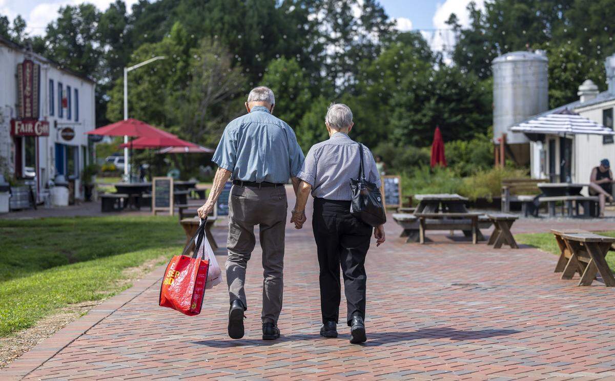 Curt and Donna Hardy of Pittsboro, N.C. walk hand in hand during their visit to The Plant and the weekly Farmer’s Market on Thursday July 10, 2025 in Pittsboro.