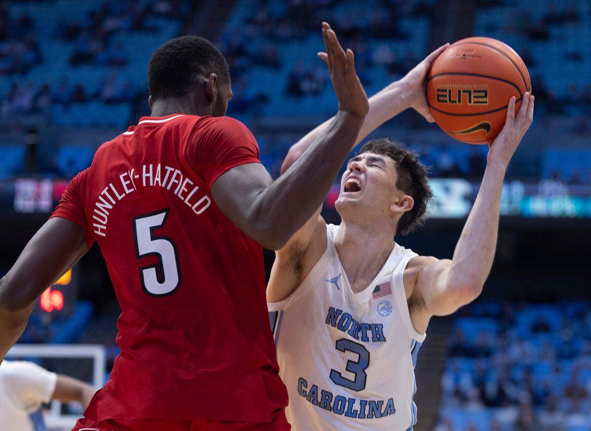 North Carolina’s Cormac Ryan (3) collides with Louisville’s Brandon Huntley-Hatfield (5) in the second half on Wednesday, January 17, 2024 at the Smith Center in Chapel Hill, N.C.