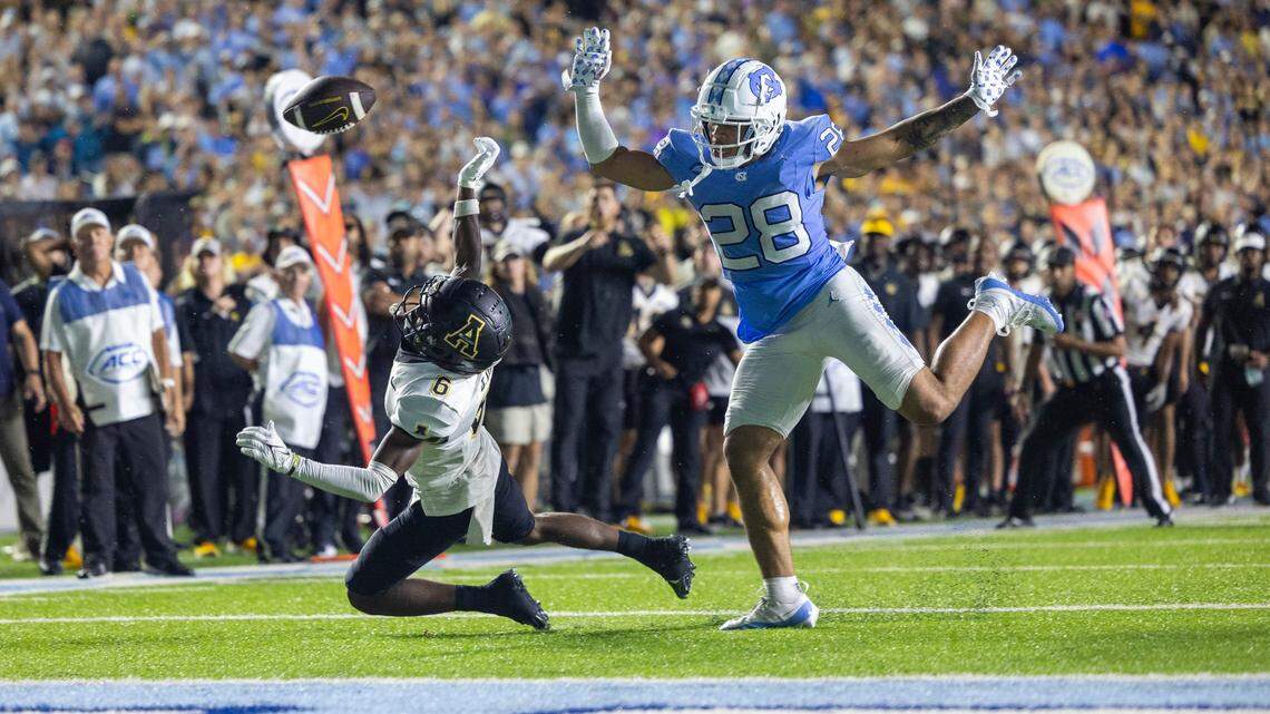 North Carolina’s Alijah Huzzie (28) defends Appalachian State’s Dashawn Davis (6) as he reaches for a pass from quarterback quarterback Joey Aguilar (4) on the final play in overtime on Saturday September 9, 2023 at Kenan Stadium in Chapel Hill, N.C. The pass was incomplete, securing the Tar Heels’ 40-34 overtime victory.