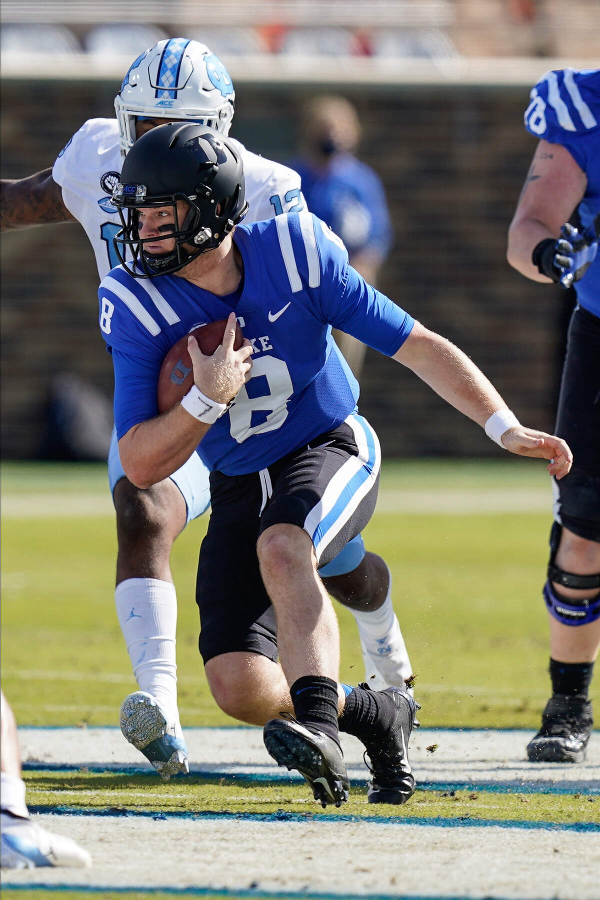 Duke Blue Devils quarterback Chase Brice (8) runs for yardage against the North Carolina Tar Heels during the first quarter at Wallace Wade Stadium. 