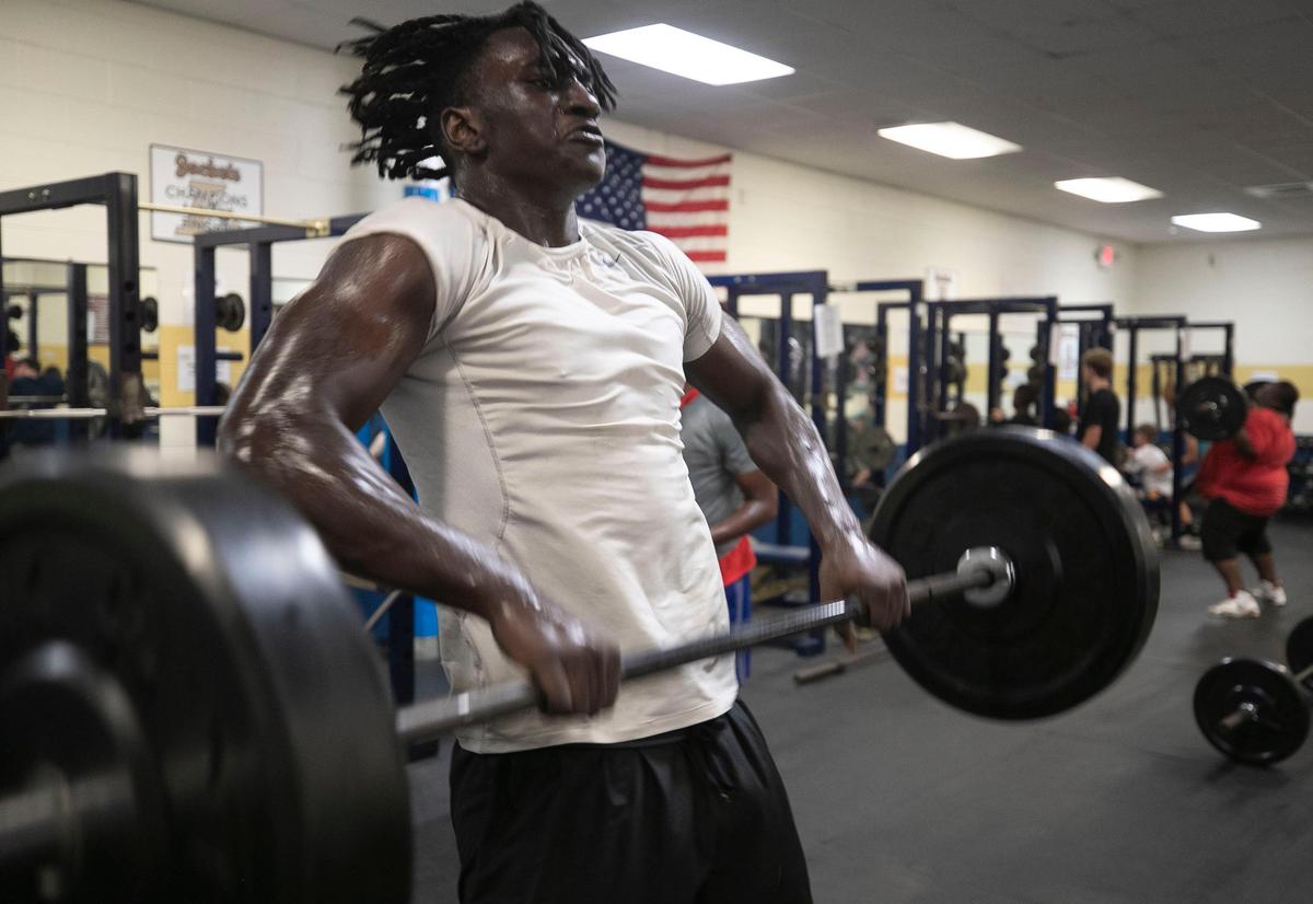 Lee County’s Desmond Evans (10), the top high school football recruit in North Carolina, works out in the weight room at Lee County High School on Wednesday, July 31, 2019 in Sanford, N.C.