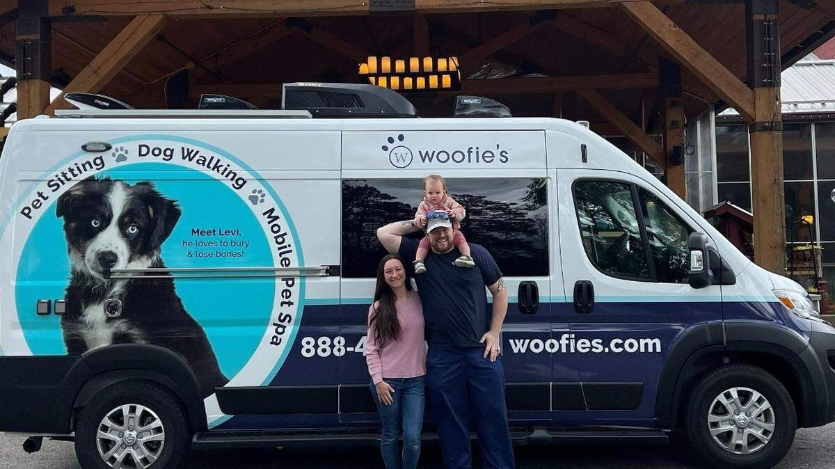 Woofie’s of Northwest Raleigh, owned by William Lee Graddy and his wife, Brittney, shown with their daughter, Piper Lee, offers mobile pet grooming, pet sitting and dog walking.