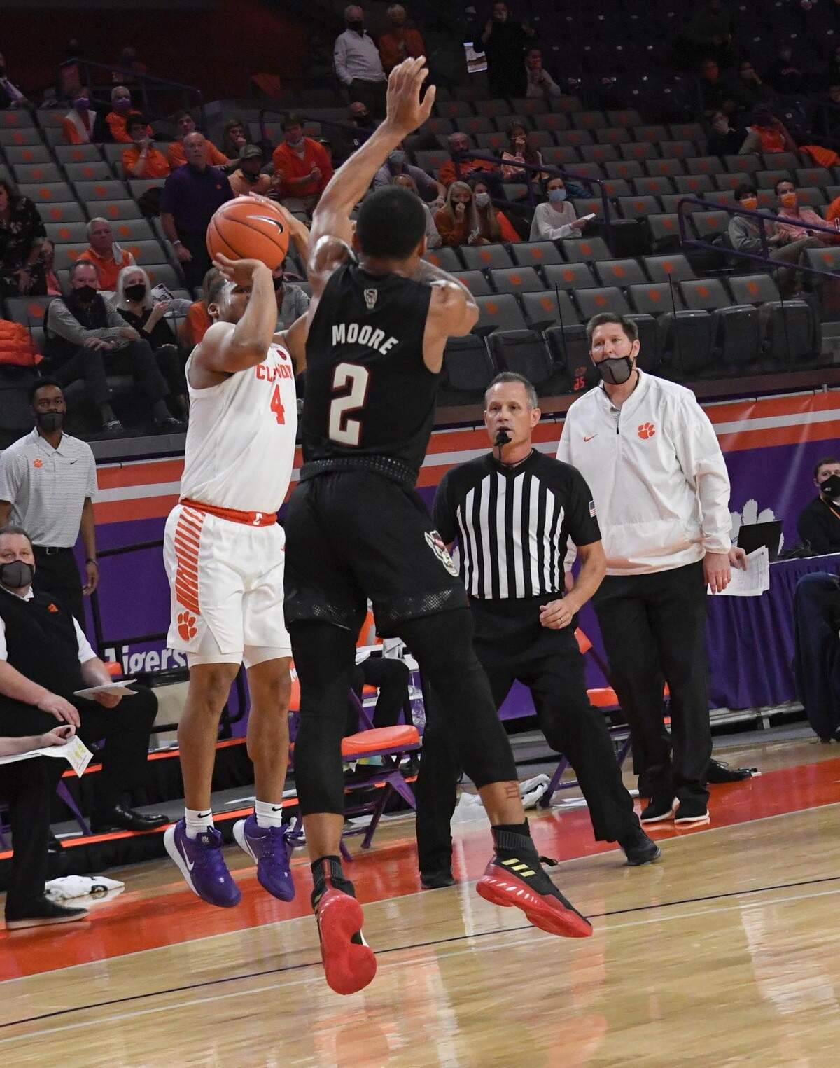 Clemson sophomore guard Nick Honor(4) makes a three-point shot as NC State guard Shakeel Moore (2) defends during their game on January 5, 2021. The shot tied the game, forcing overtime.