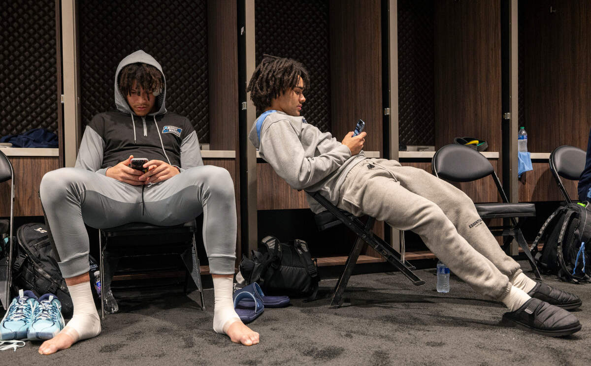 North Carolina’s James Okonkwo (32) and Elliot Cadeau (2) check their phones in the locker room prior to the Tar Heels’ practice on Wednesday, March 27, 2024 at Crypto.com Arena in Los Angeles, CA.