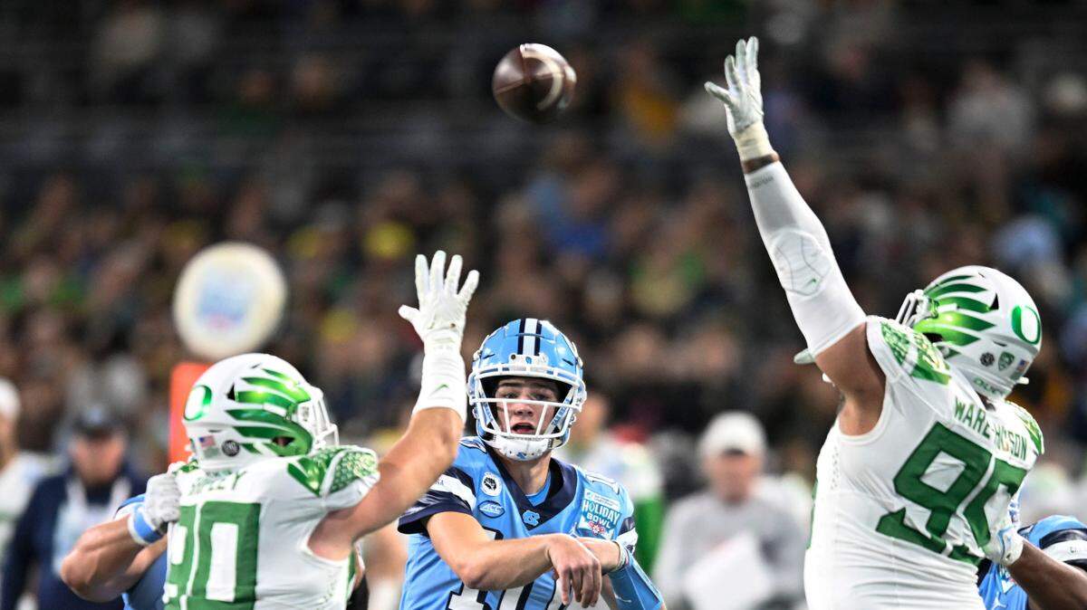 North Carolina quarterback Drake Maye (throws over Oregon defenders during the 2022 Holiday Bowl in San Diego. Maye., a Heisman Trophy candidate, has one of college football’s highest potential NIL values.