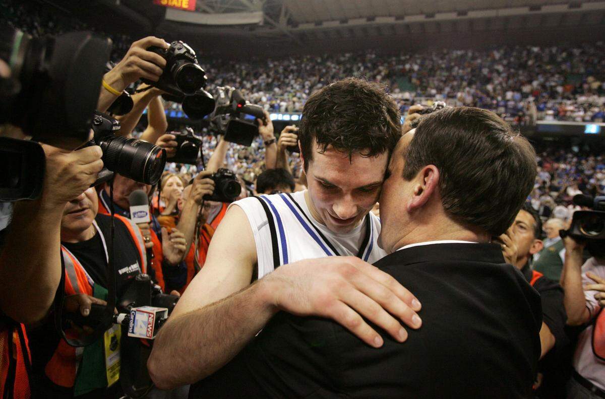 J.J. Redick and Mike Krzyzewski hug after Duke won the ACC Championship by beating Boston College 78-76 in 2006.  Redick had 26 points in the victory and was named MVP of the tournament.