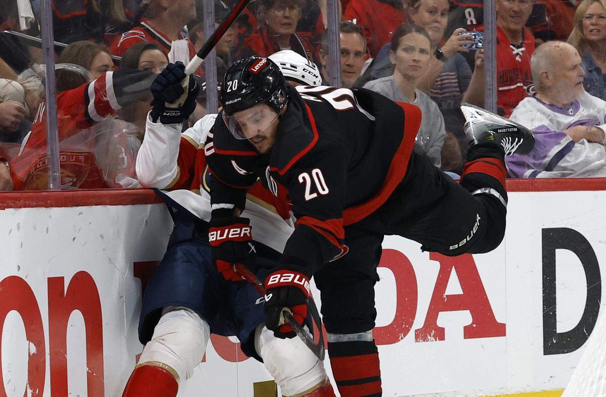 Carolina’s Sebastian Aho (20) checks Panthers’ Anton Lundell (15) during the first period of the Carolina Hurricanes’ game against the Florida Panthers in Game 1 of the Eastern Conference Finals at the Lenovo Center in Raleigh, N.C., Tuesday, May 20, 2025.