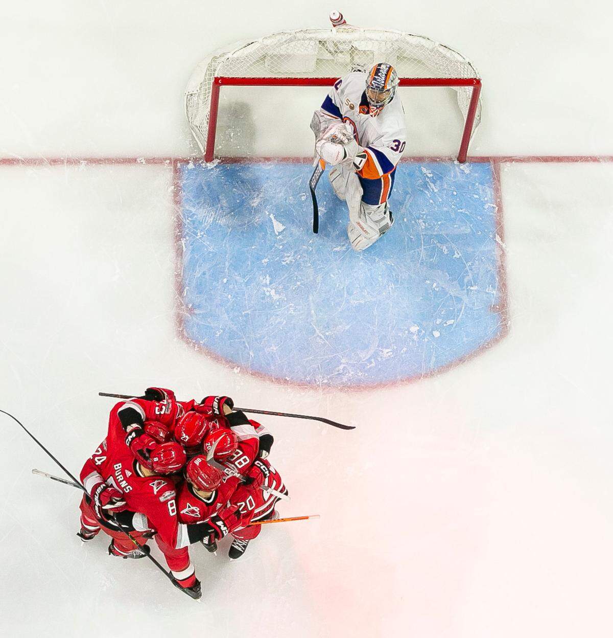 Carolina Hurricanes’ Stefan Noesen (23) is surrounded by teammates after scoring on New York Islanders’ goalie Ilya Sorokin (30) in the second period on Monday, April 17, 2023 at PNC Arena in Raleigh, N.C.