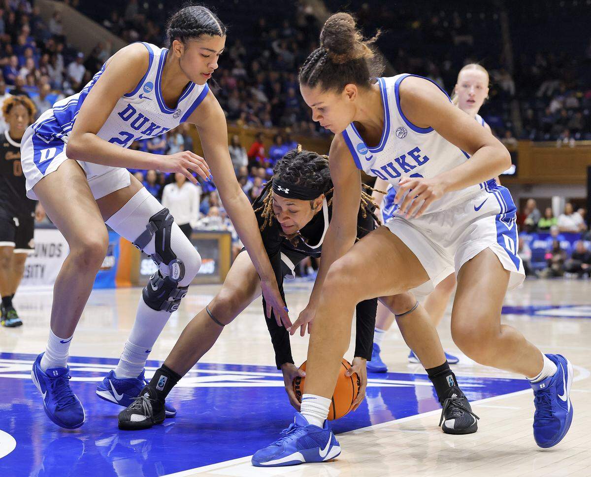 Duke’s Arianna Roberson and Delaney Thomas pressure College of Charleston’s Marissa Brown during the second half of the Blue Devils’ 81-64 first-round NCAA Tournament win on Friday, March 20, 2026, at Cameron Indoor Stadium in Durham, N.C.