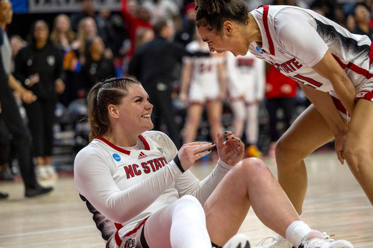 NC State’s River Baldwin (1) and Madison Hayes (21) celebrate after Baldwin was fouled after scoring two late in the second half against Tennessee’s during the second round of the Division I Women’s Basketball Championship at Reynolds Coliseum in Raleigh, North Carolina, on March 25, 2024.