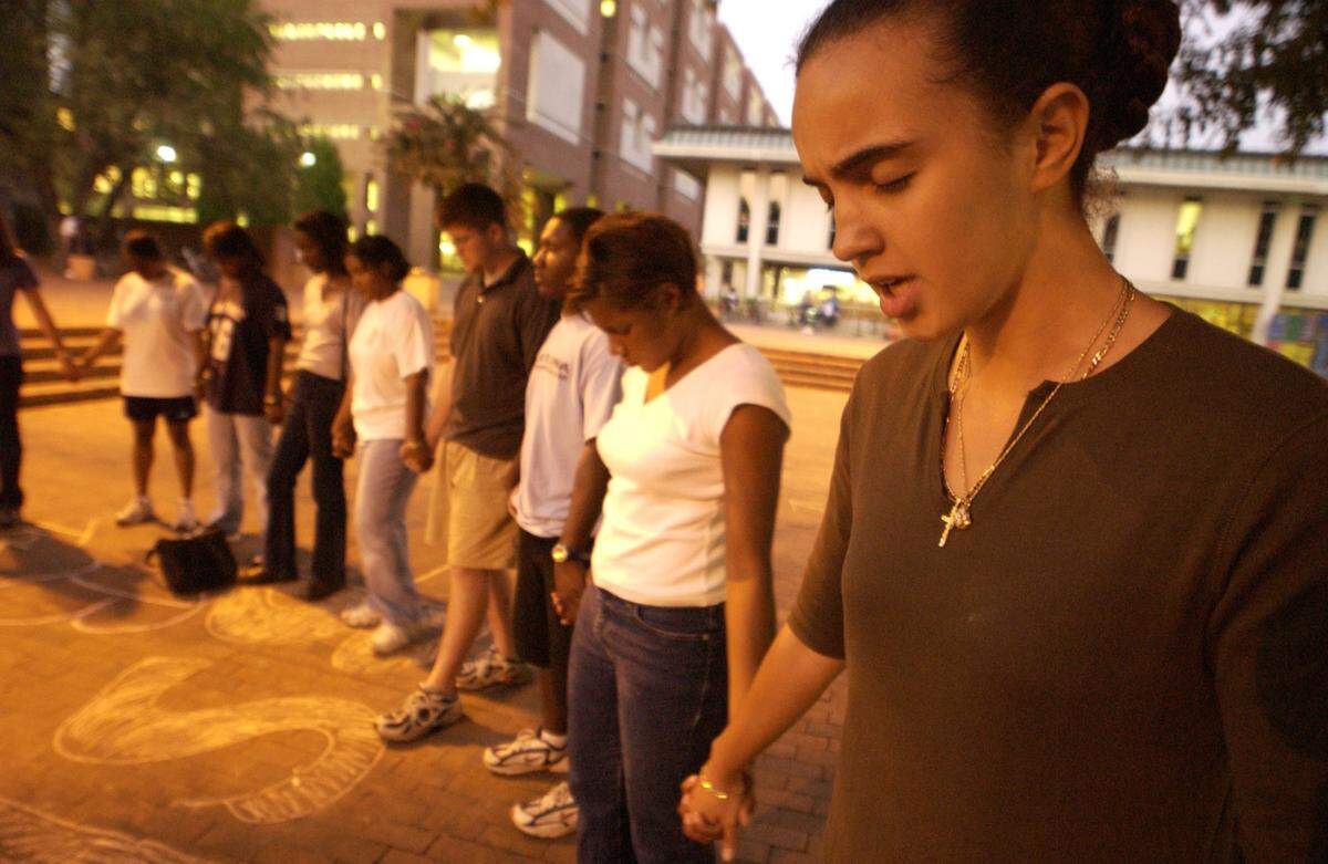 Patience Whitehead (far right), a junior in Biology and Education, and other students pray for God’s wisdom and will to prevail during a prayer vigil for victims of the Sept. 11, 2001, terrorist attacks against the United States Tuesday Sept 11. at The Pit at the UNC campus in Chapel Hill, N.C.