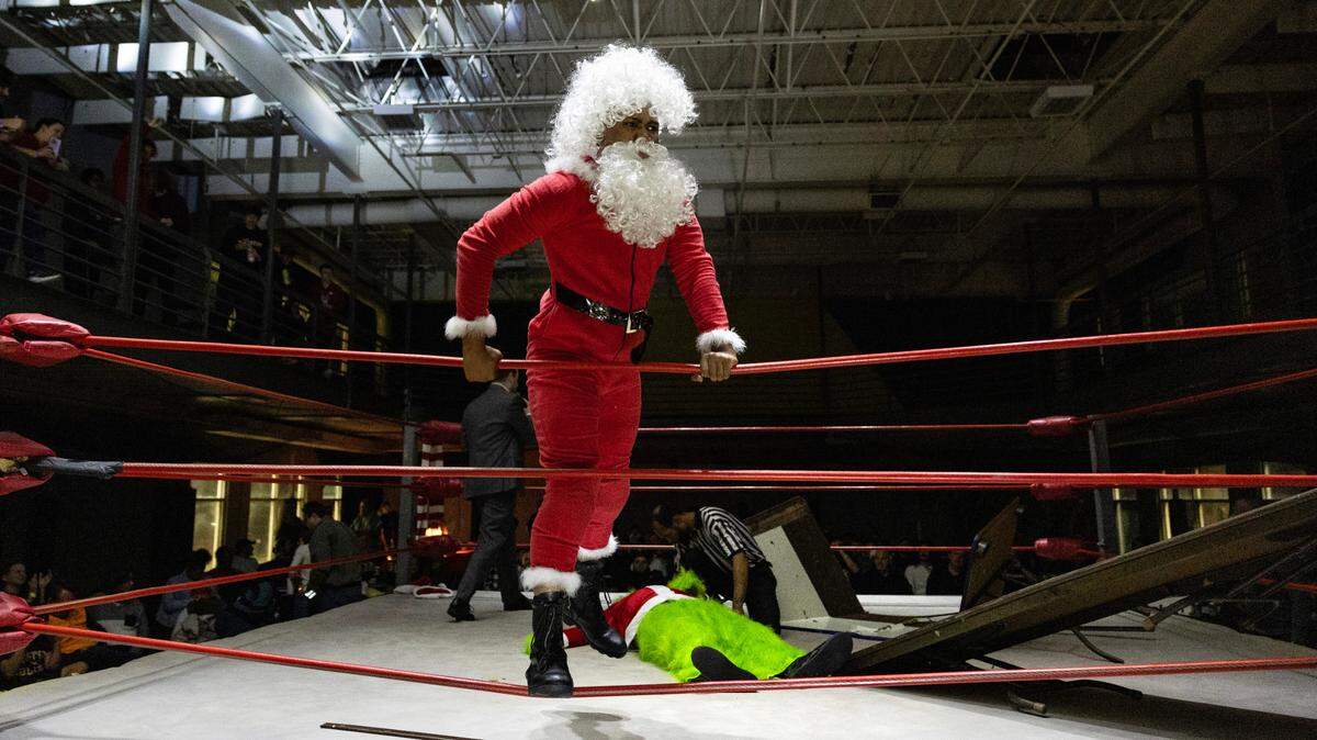 Santa celebrates after defeating The Grinch at FWE Merry Mayhem in Cary, N.C., Saturday night, Dec. 14, 2024.