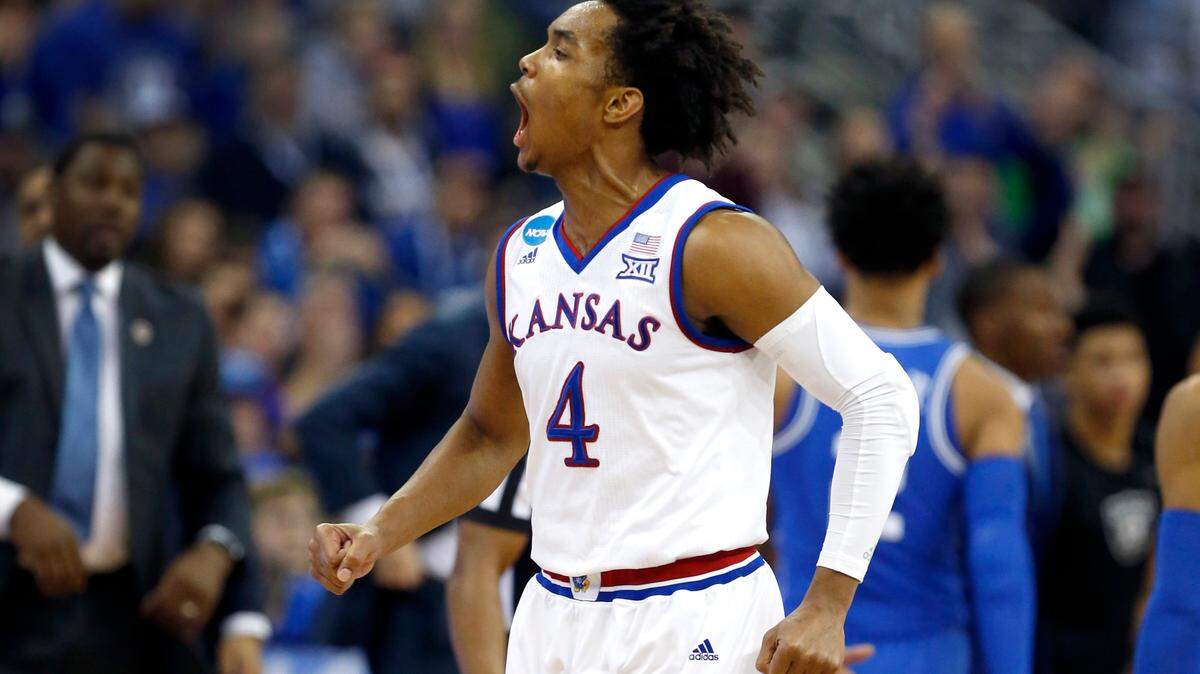 Kansas' Devonte' Graham (4) celebrates as a timeout is called during the second half of Kansas' 85-81 victory over Duke.