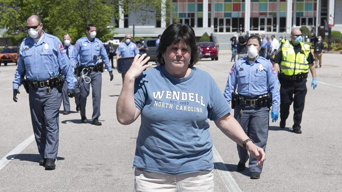 Regina Harmon, owner of the Wendell General Store, marches in a Reopen NC protest in downtown Raleigh in April. Her store now has a sign that urges customers not to wear a mask, falsely claiming that state law bans face masks in public places.