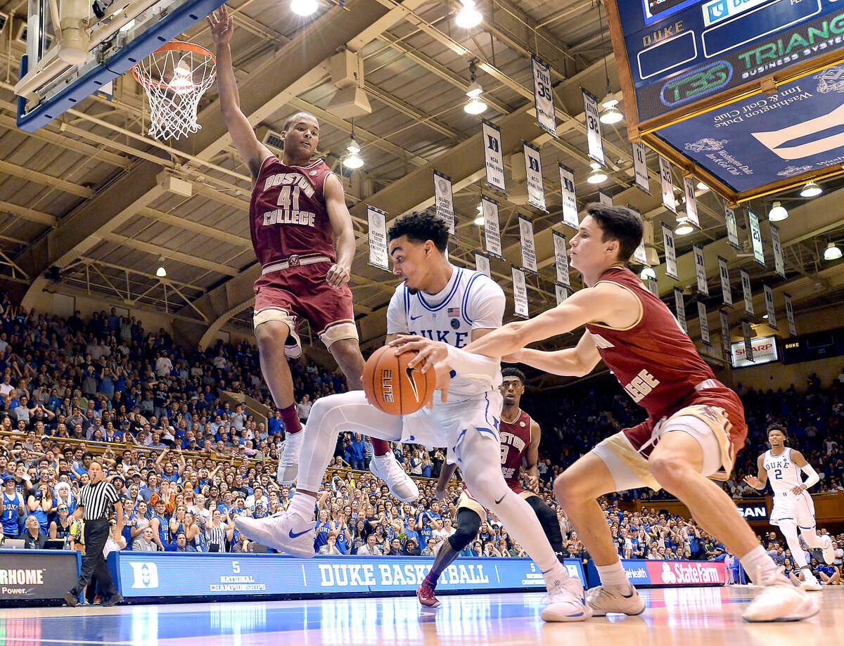 Duke guard Tre Jones (3) is fouled by Boston College guard Chris Herren Jr. (4) after grabbing a second half rebound following the play is Boston College forward Steffon Mitchell (41).