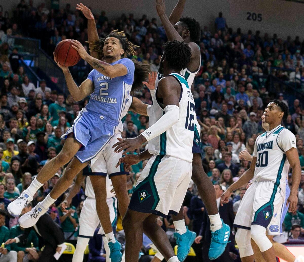 North Carolina’s Cole Anthony (2) breaks to the basket past UNC-W’s Imajae Dodd (24) during the first half on Friday, November 8, 2019 at Trask Coliseum in Wilmington, N.C. Anthony lead all scores with 20 points in the Tar Heels’ 78-62 victory.