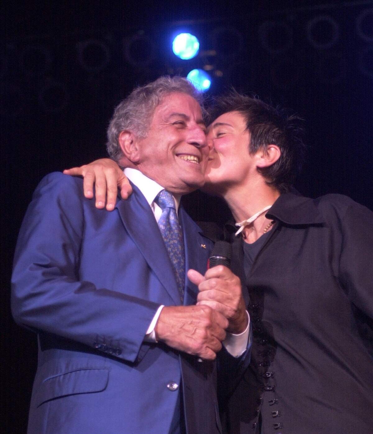 Tony Bennett gets a surprise kiss from k.d. lang before she started singing segment at their concert at Raleigh’s Walnut Creek Pavillion Sunday Aug. 5, 2001.