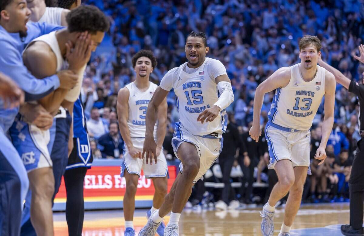 North Carolina forward Jarin Stevenson (15) and center Henri Veesaar (13) race toward teammate Seth Trimble after he sank the game winning shot with .4 seconds to play, giving the Tar Heels’ a 71-68 victory on Saturday, February 7, 2026 at the Smith Center in Chapel Hill, N.C.