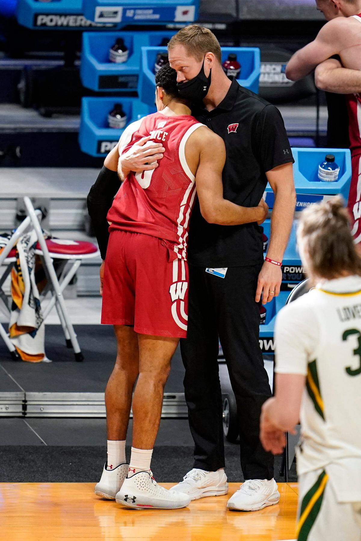 Wisconsin guard D’Mitrik Trice (0) hug a member of the basketball staff after leaving the game in the second half of a second-round game in the NCAA men’s college basketball tournament at Hinkle Fieldhouse in Indianapolis, Sunday, March 21, 2021. Baylor defeated Wisconsin 76-63. 