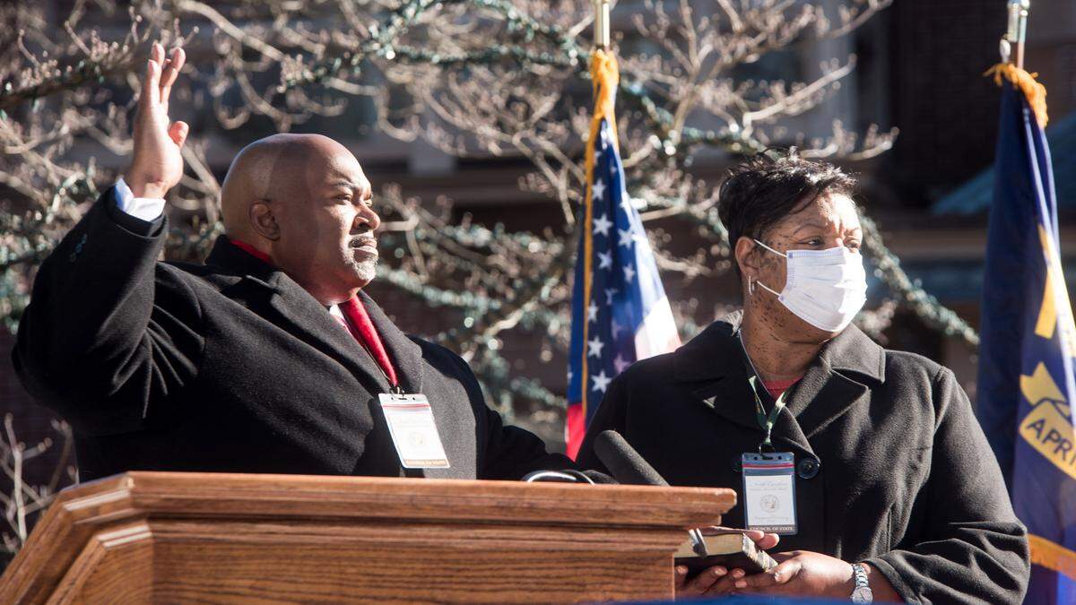 North Carolina Lieutenant Governor Mark Robinson takes the oath of office as he is sworn into office on Saturday morning. The ceremony has limited in-person attendance due to COVID-19.