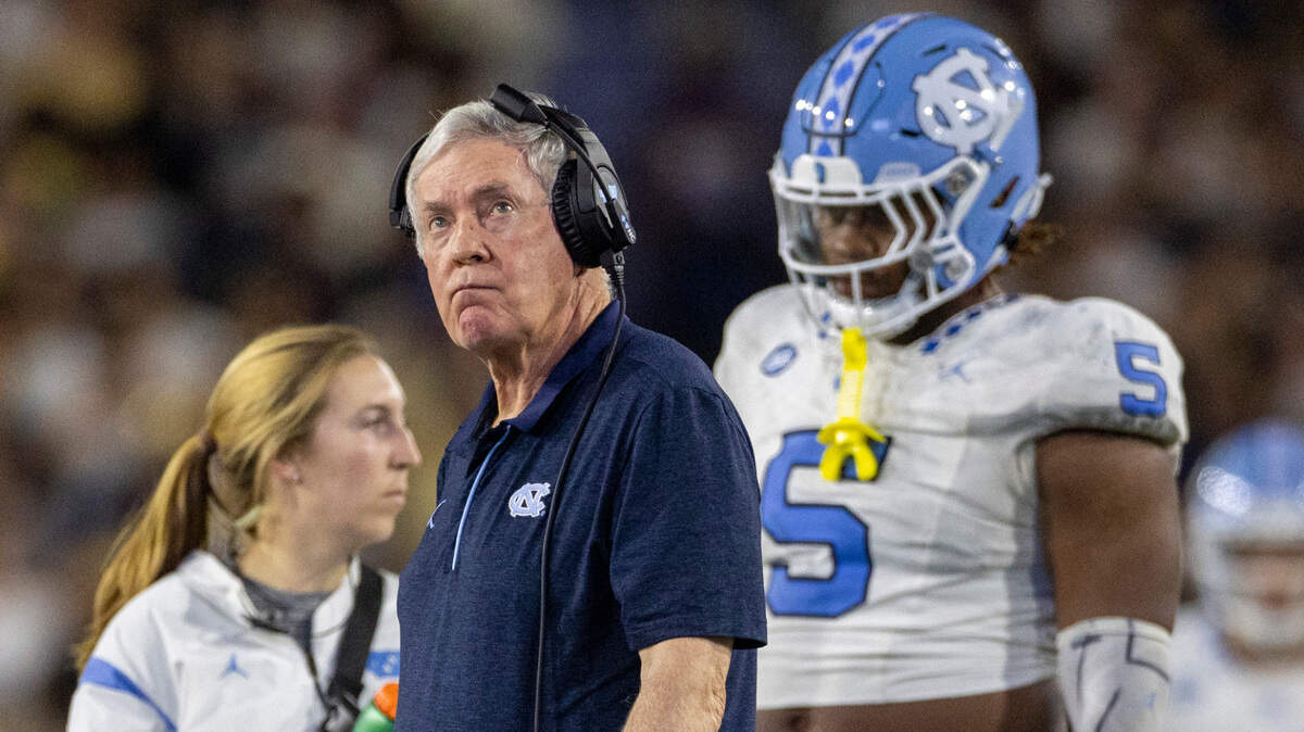 North Carolina coach Mack Brown checks the video replay as he walks to check on Devontez Walker (9) who was injured by Georgia Tech’s Kyle Efford (44) and Ahmari Harvey (18) in the fourth quarter on Saturday, October 28, 2023 at Bobby Dodd Stadium in Atlanta, Georgia.