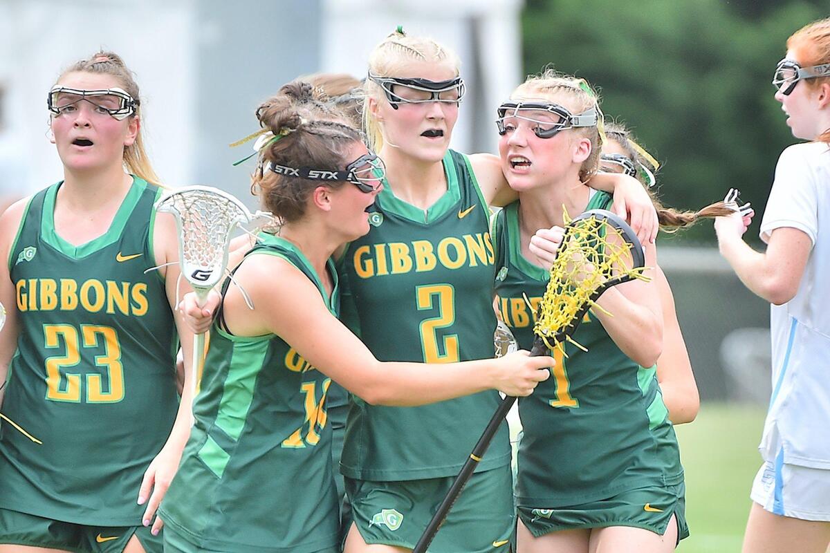 CArdial Gibbons’ Gracie Mullahy (2) celebrates with teammates after her goal during the first half. The Cardinal Gibbons Crusaders and the Charlotte Catholic Cougars met in the NCHSAA Women’s Lacrosse Championships in Cary, N.C. on May 21, 2022.