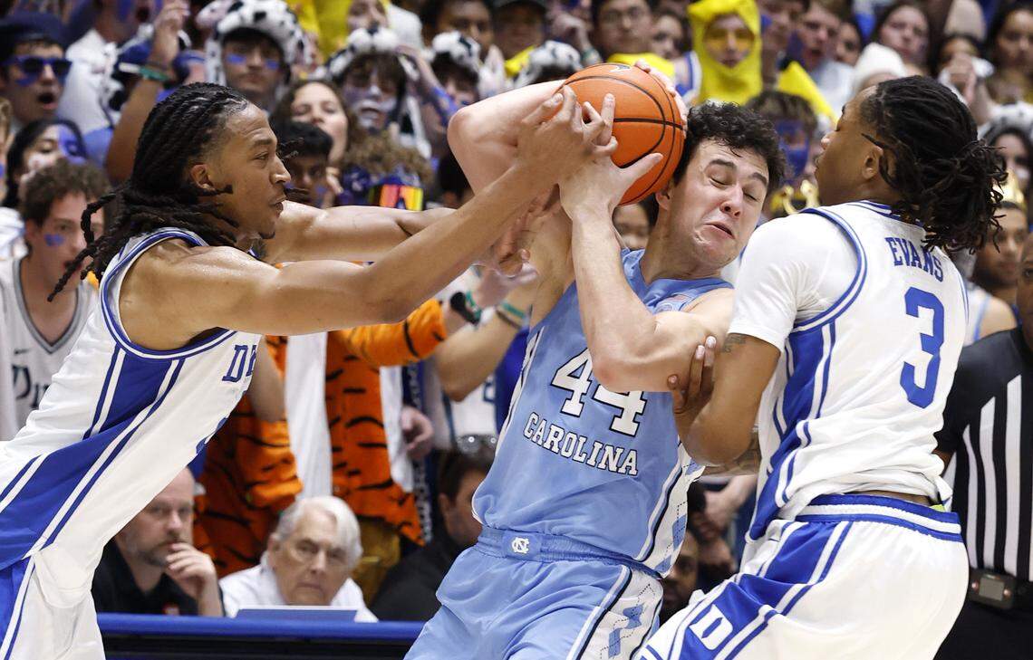 Duke’s Maliq Brown (6) pressures North Carolina's Luka Bogavac (44) as Isaiah Evans (3) also defends during the first half of Duke’s game against UNC at Cameron Indoor Stadium in Durham, N.C., Saturday, March 7, 2026.