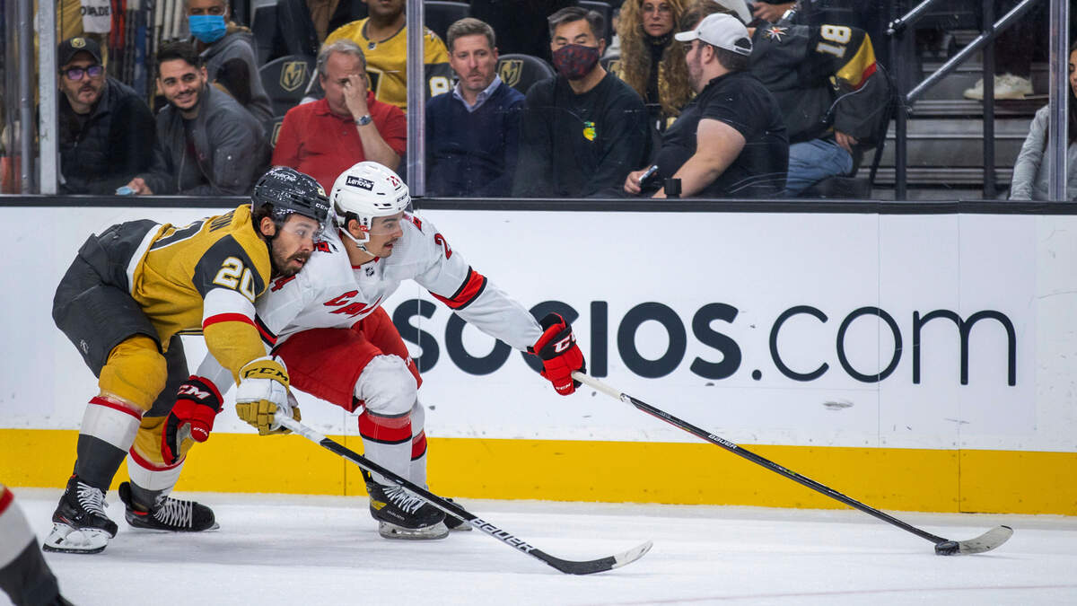Vegas Golden Knights center Chandler Stephenson (20) and Carolina Hurricanes center Seth Jarvis (24) vie for the puck during the first period of an NHL hockey game Tuesday, Nov. 16, 2021, in Las Vegas. (AP Photo/L.E. Baskow)