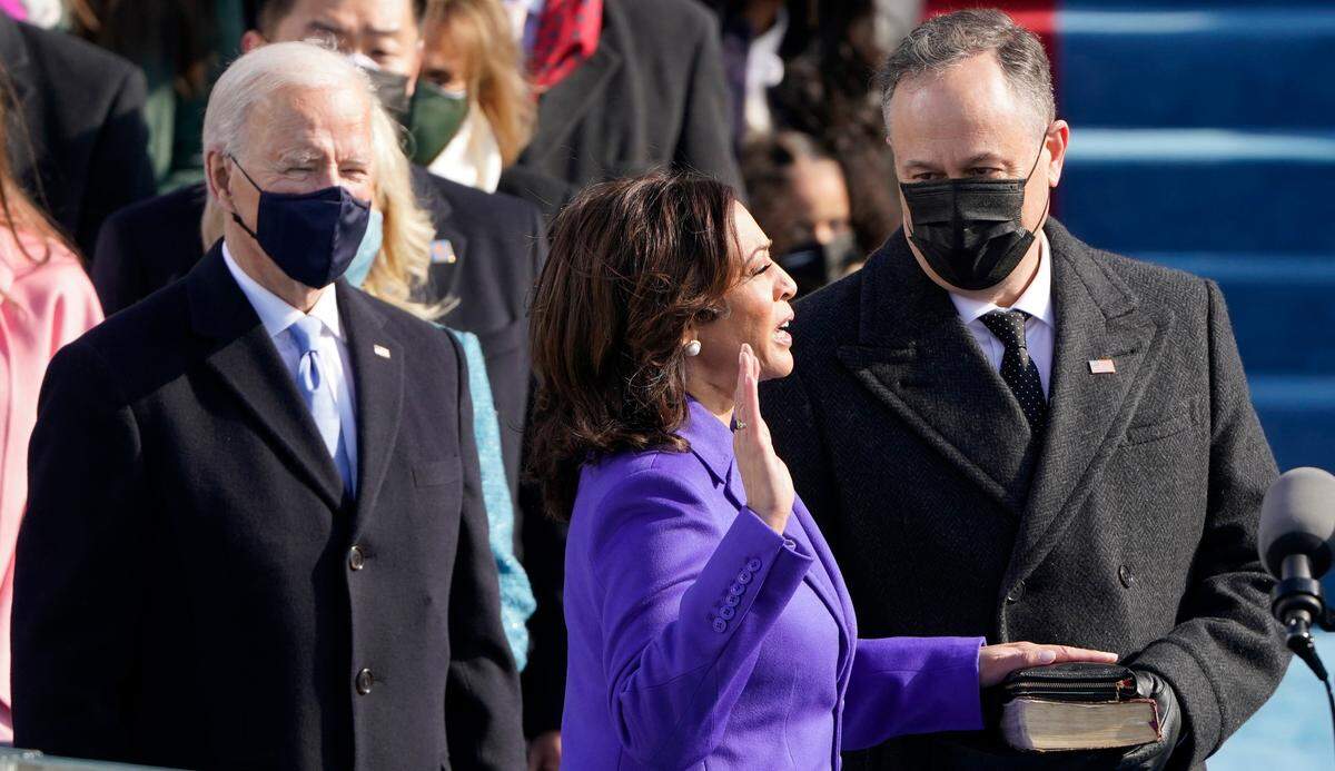Kamala Harris is sworn in as vice president by Supreme Court Justice Sonia Sotomayor as her husband Doug Emhoff holds the Bible during the 59th Presidential Inauguration at the U.S. Capitol in Washington, Wednesday, Jan. 20, 2021.