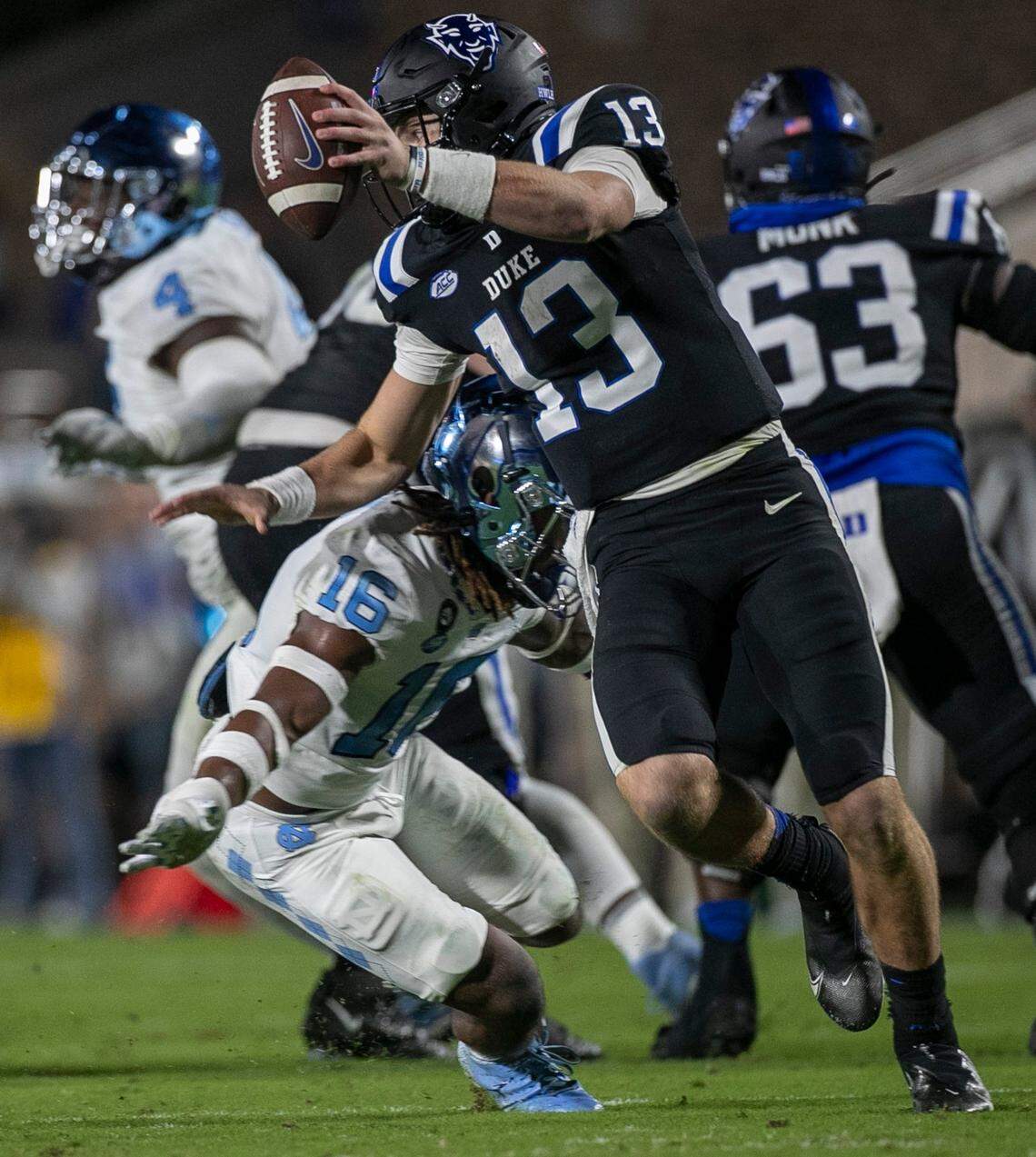 Duke quarterback Riley Leonard (13) is sacked by North Carolina’s DeAndre Boykins (16) in the second quarter on Saturday, October 15, 2022 at Wallace-Wade Stadium in Durham, N.C.