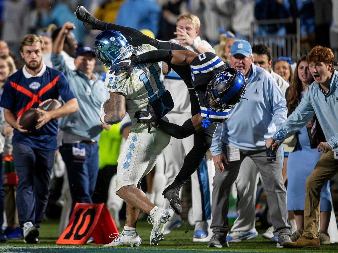 Duke’s Chandler Rivers (0) pushes North Carolina wide receiver Josh Downs (11) out of bounds after an 11-yard pass receptions from quarterback Drake Maye to set up the Tar Heels’ winning touchdown in the final minute of play on Saturday, October 15, 2022 at Wallace-Wade Stadium in Durham, N.C.