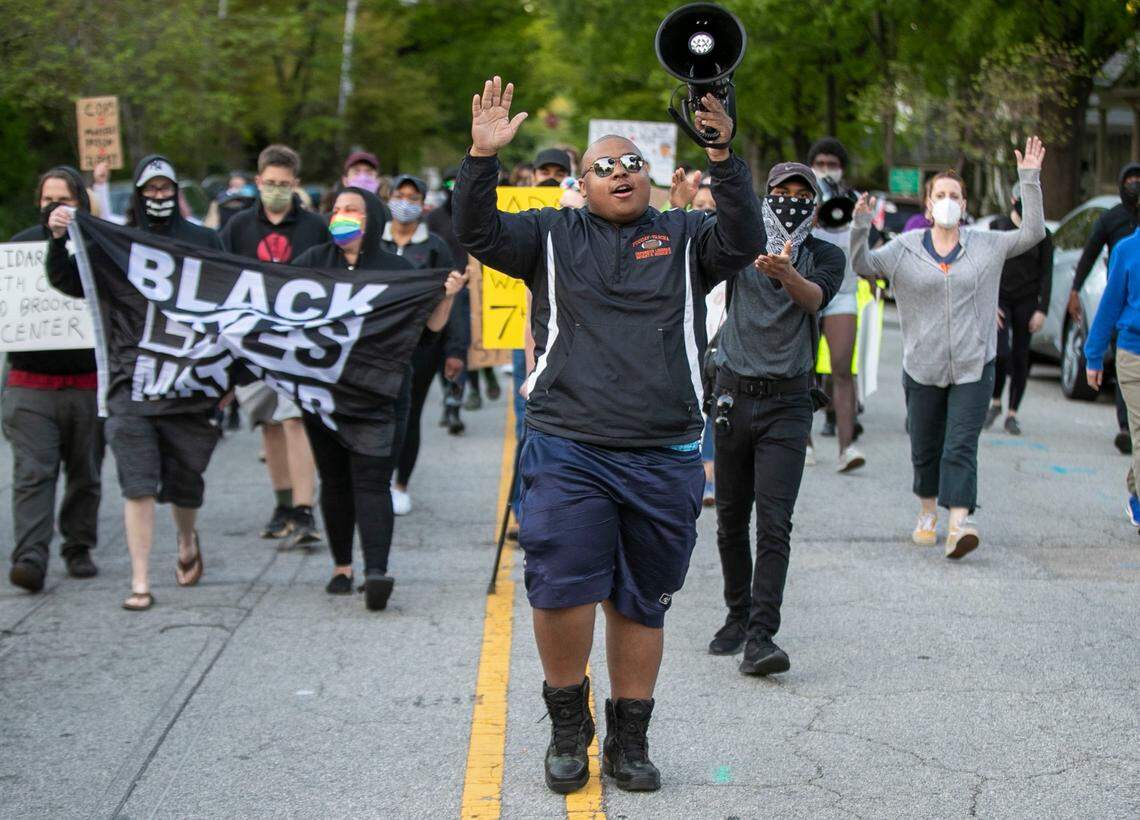 Demonstrators march on Bloodworth Street in the Oakwood neighborhood calling for an end to police violence on Friday, April 16, 2021 in Raleigh, NC. Raleigh Police ordered the demonstrators to move off of the street and on to the sidewalk or face arrest.