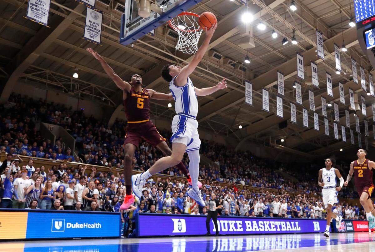 Duke’s Darren Harris (8) puts the ball in the basket past Arizona State’s Amier Ali (5) during Duke’s 103-47 victory over Arizona State in the Brotherhood Run Charity Game at Cameron Indoor Stadium in Durham, N.C., Sunday, Oct. 27, 2024.