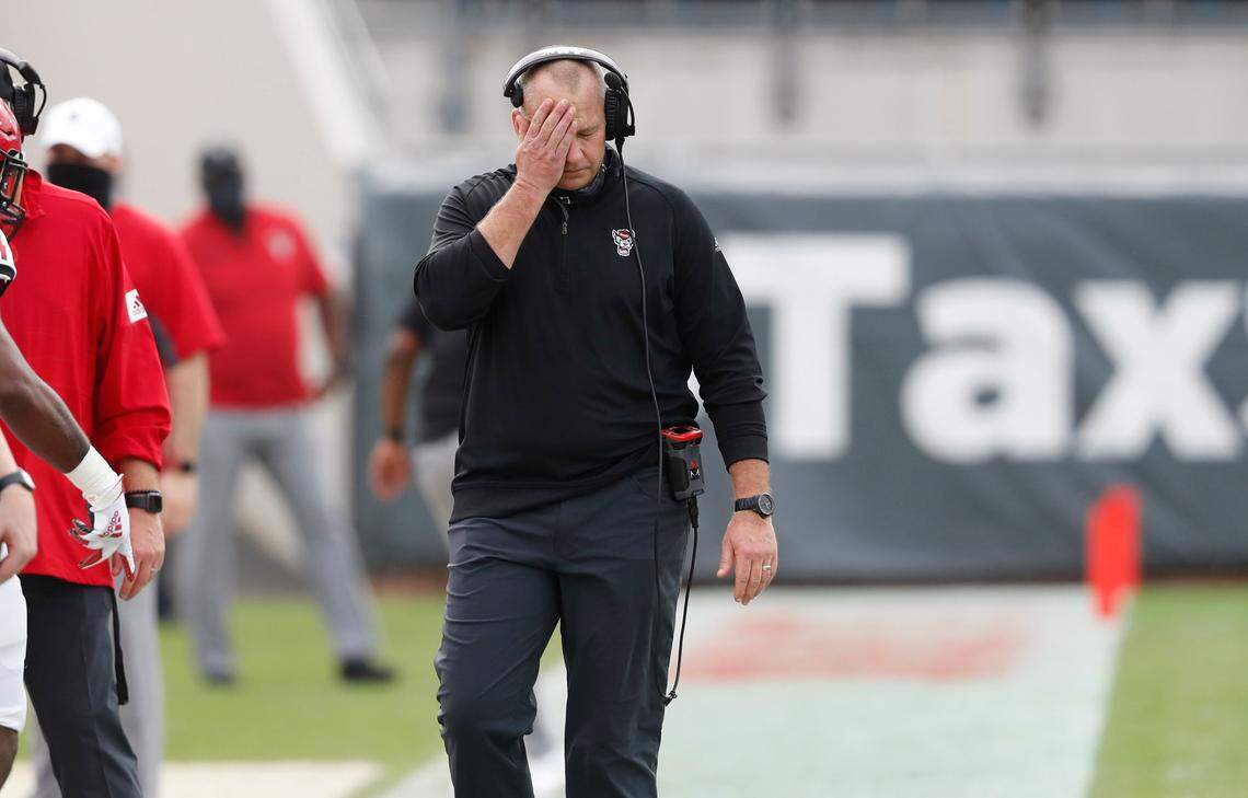 N.C. State head coach Dave Doeren wipes the sweat from his brow during the first half of N.C. State’s game against Kentucky in the Gator Bowl at TIAA Bank Field in Jacksonville, Fla., Saturday, January 2, 2021.