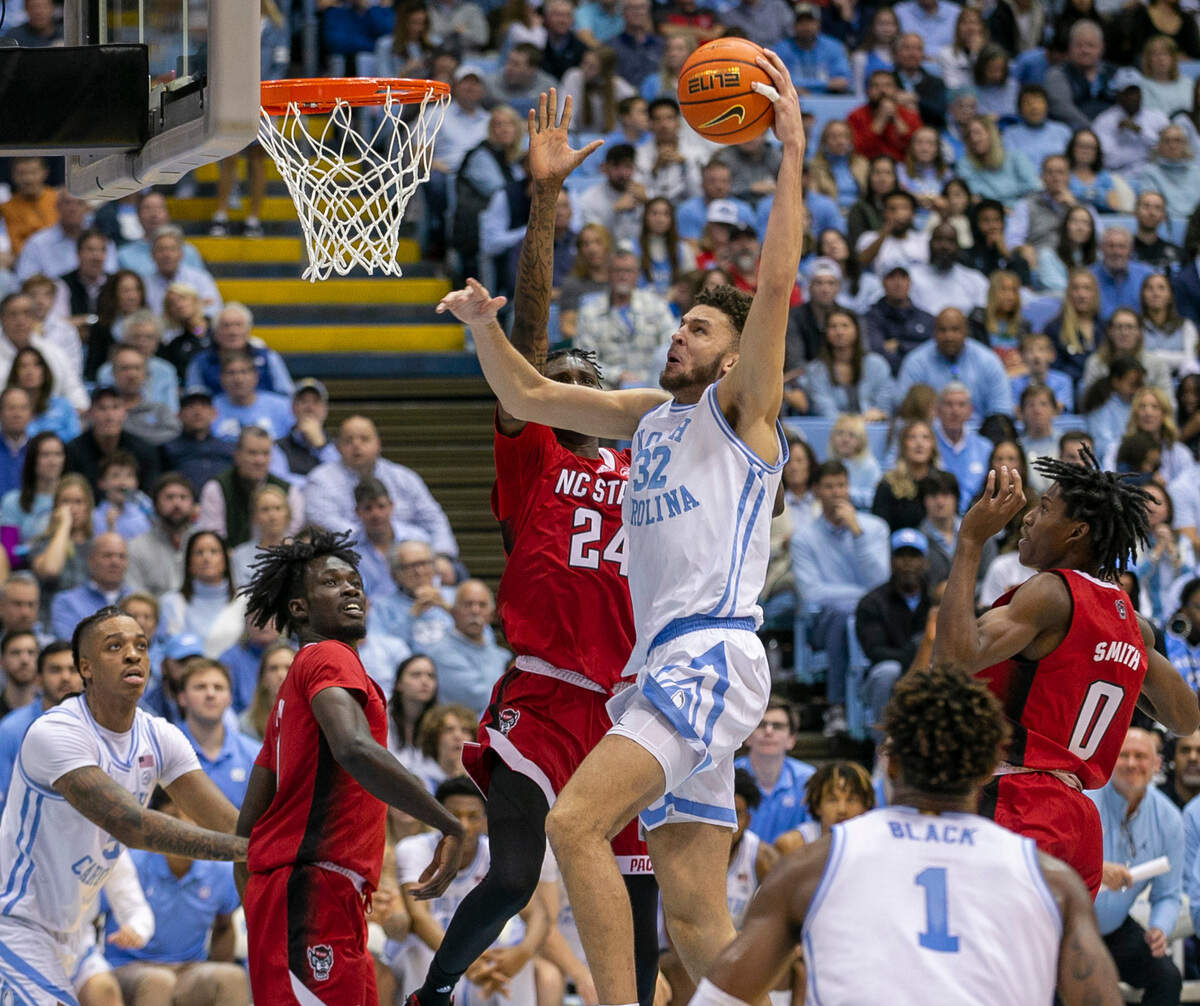 North Carolina’s Pete Nance (32) dunks on N.C. State’s Ernest Ross (24) during the second half on Saturday, January 21, 2023 at the Smith Center in Chapel Hill, N.C.