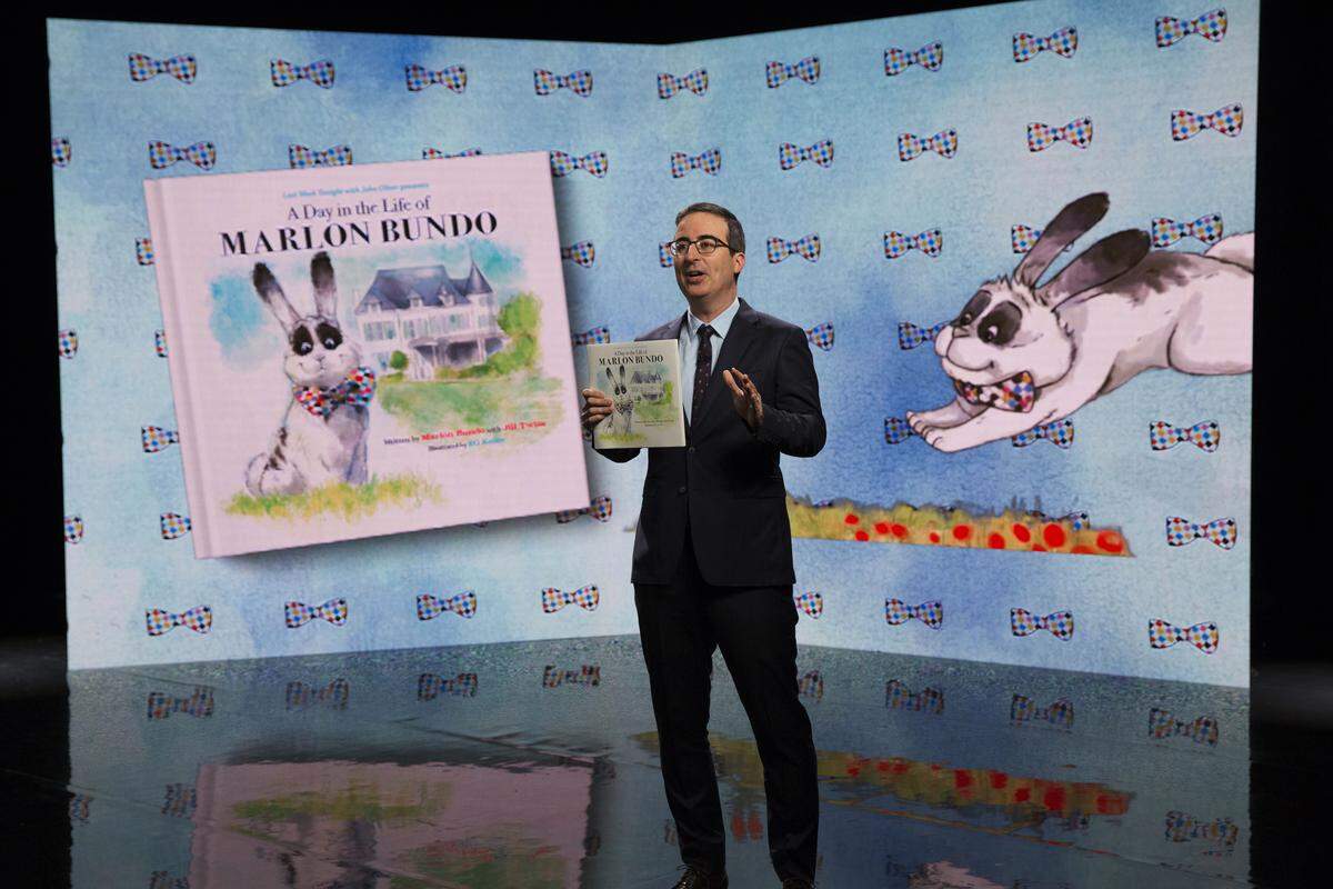 In this March 2018 photo provided by HBO, John Oliver holds the book "Last Week Tonight with John Oliver Presents a Day in the Life of Marlon Bundo."