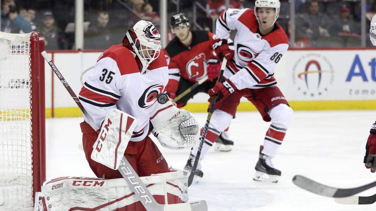 Carolina Hurricanes goaltender Curtis McElhinney (35) blocks a shot from the New Jersey Devils during the second period of an NHL hockey game, Saturday, Dec. 29, 2018, in Newark, N.J. (AP Photo/Julio Cortez)