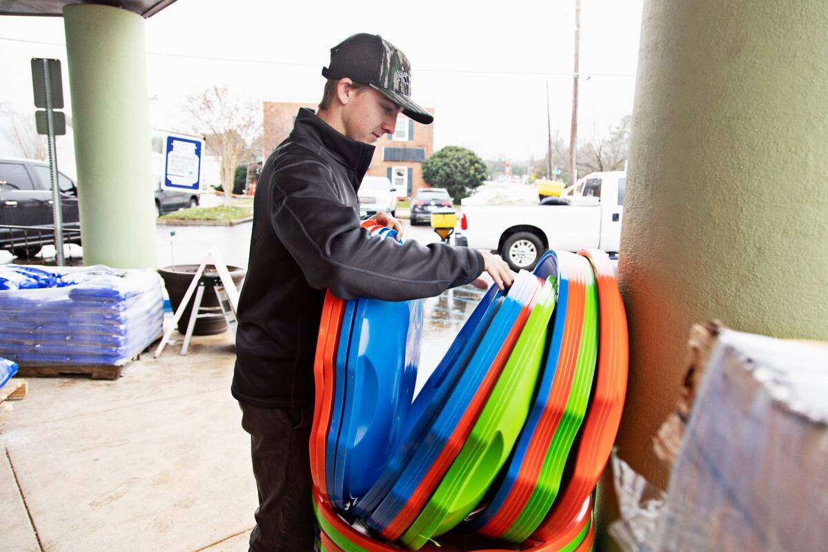 Tripp Phillips checks out the sleds at Burke Brothers Hardware on Thursday morning, Jan. 20, 2022, in advance of anticipated snow. Phillips, a junior at NCSU, stopped in the store for something else but decided to also buy a sled to Òsplit with his roommates.Ó