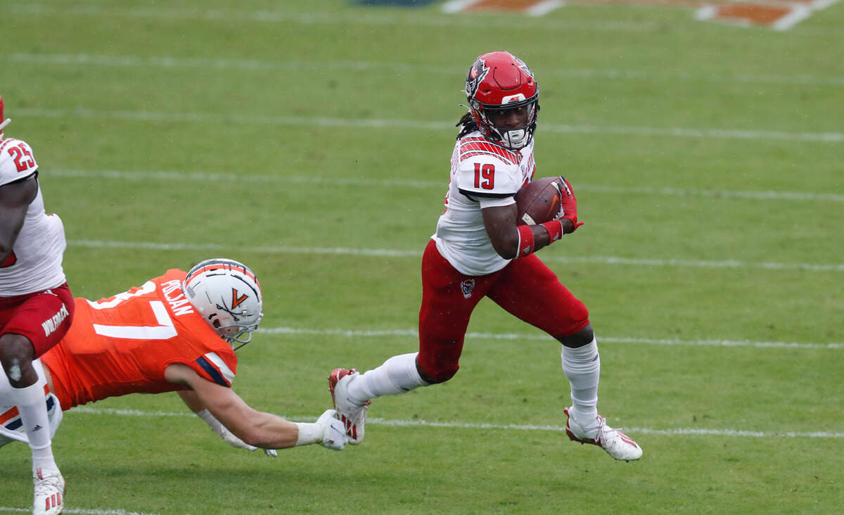 N.C. State defensive back Joshua Pierre-Louis (19) runs back after making an interception during the first half of N.C. State’s game against Virginia at Scott Stadium in Charlottesville, Va., Saturday, Oct. 10, 2020.