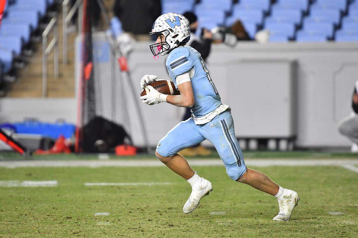 Watauga's Evan Burroughs (12) runs the ball during kickoff return during the second half against Middle Creek. The Middle Creek Mustangs and the Watauga Pioneers met in the NCHSAA 6A Football Championship game in Chapel Hill, N.C. on December 12, 2025. 