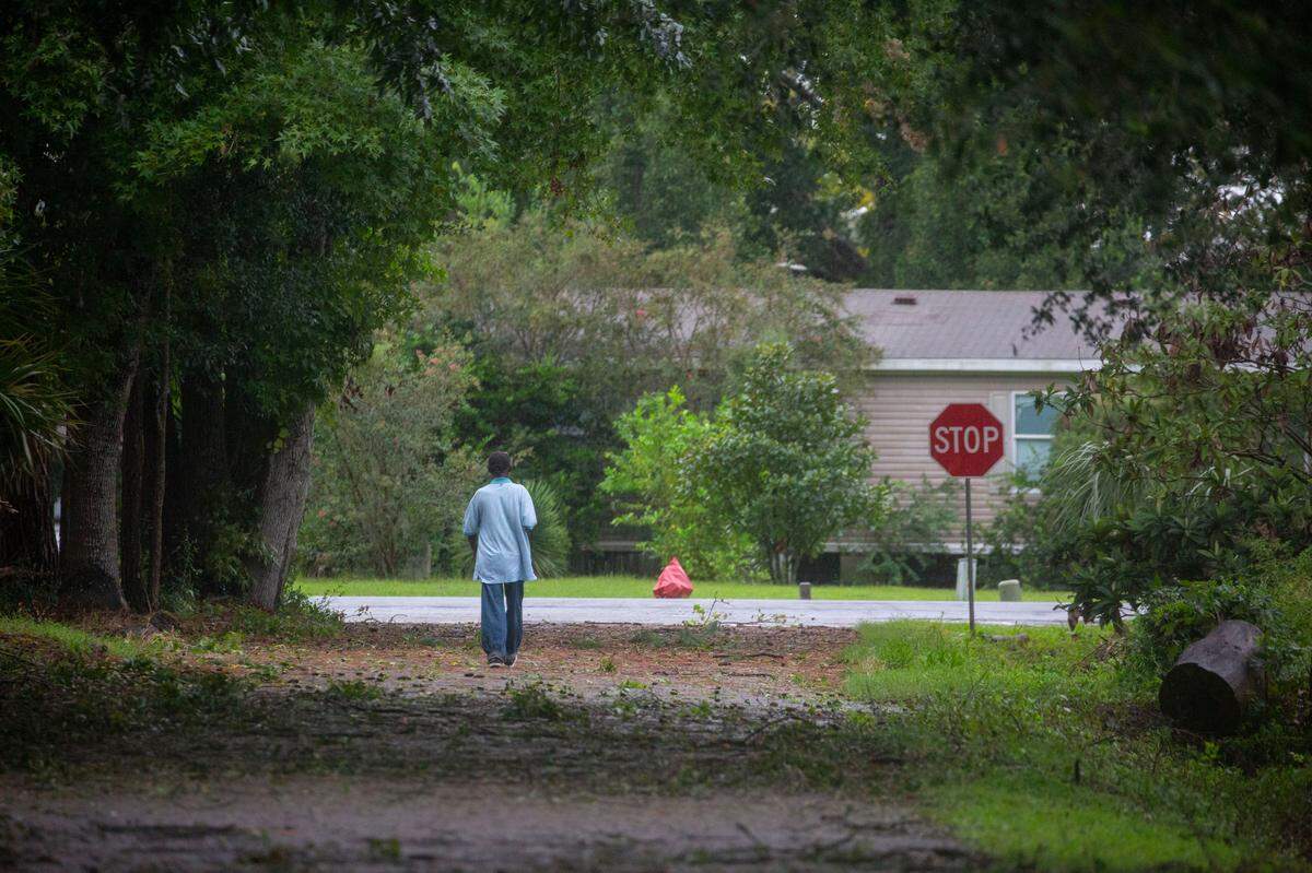 A man walks down the street in the Squire Pope neighborhood on Hilton Head Island after the eye of Hurricane Dorian traveled north off the South Carolina coast, Thursday September 5, 2019. Jessica Koscielniak / jkoscielniak@mcclatchy.com)