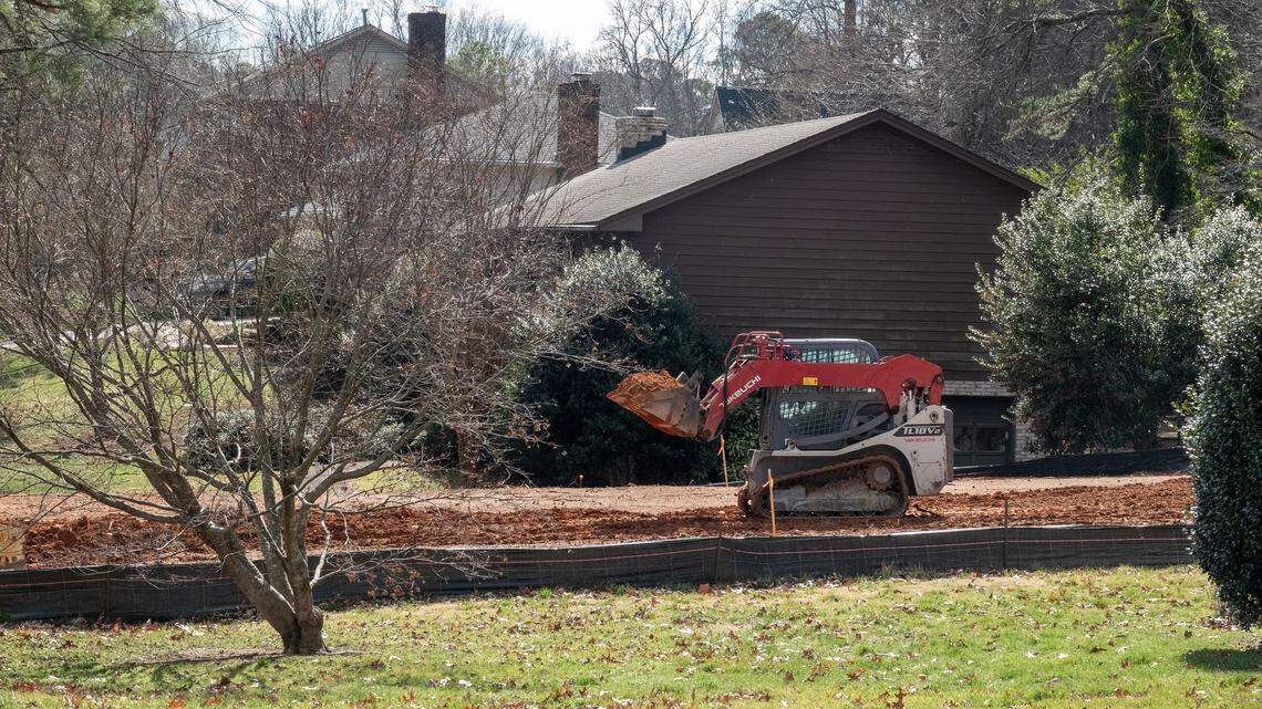 A compact track loader works the lot after the original house was torn down at 7817 Audubon Drive in North Raleigh, NC Feb. 23, 2026.