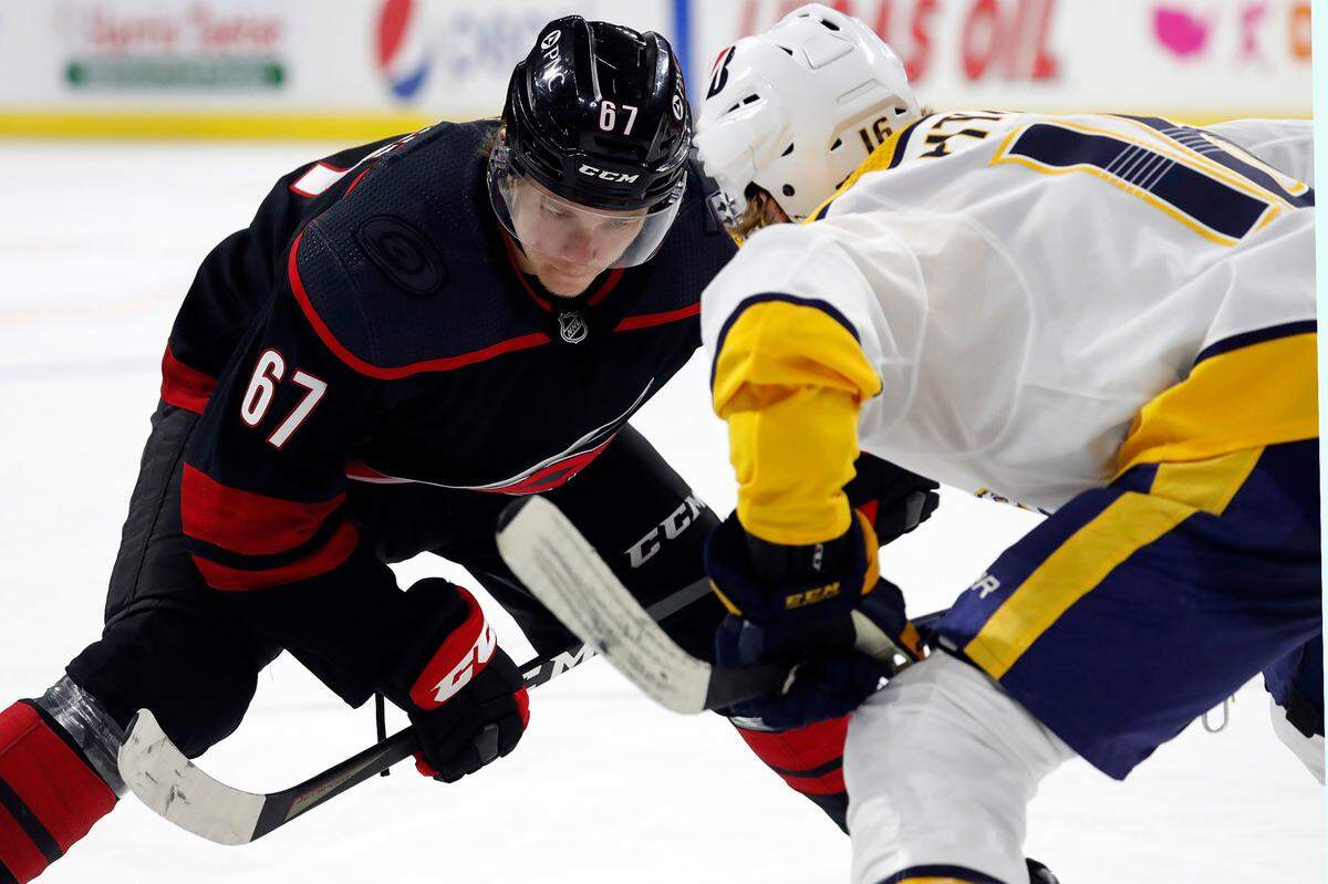 Carolina Hurricanes’ Morgan Geekie (67) faces off against Nashville Predators’ Rem Pitlick (16) during the second period of an NHL hockey game in Raleigh, N.C., Thursday, March 11, 2021. (AP Photo/Karl B DeBlaker)