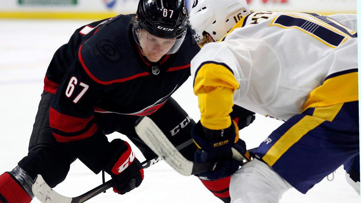 Carolina Hurricanes’ Morgan Geekie (67) faces off against Nashville Predators’ Rem Pitlick (16) during the second period of an NHL hockey game in Raleigh, N.C., Thursday, March 11, 2021. (AP Photo/Karl B DeBlaker)