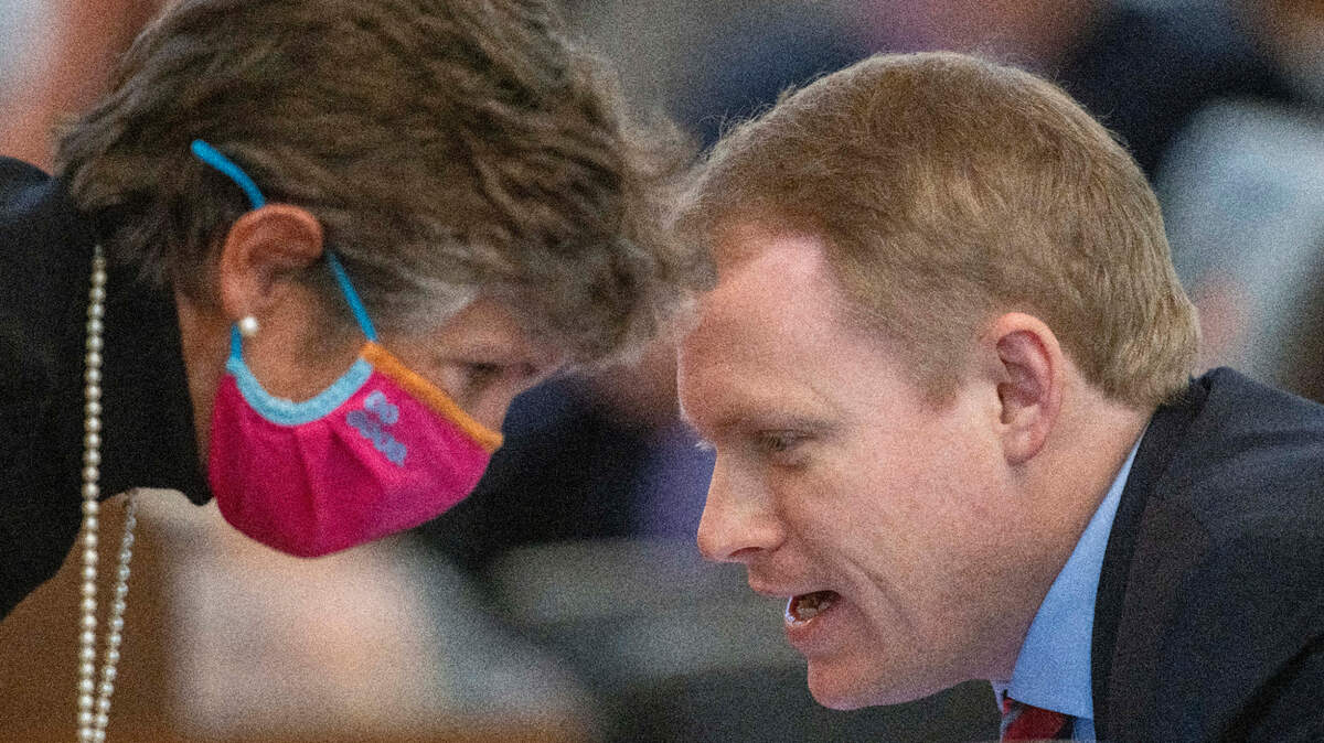 Rep. Pricey Harrison of Guilford County confers with Rep. Destin Hall of Lenoir, N.C. during the House session on Thursday, November 4, 2021 in Raleigh, N.C. Hall defended the drawing of the new redistricting maps, and Harrison objected to the splitting of Guilford County.